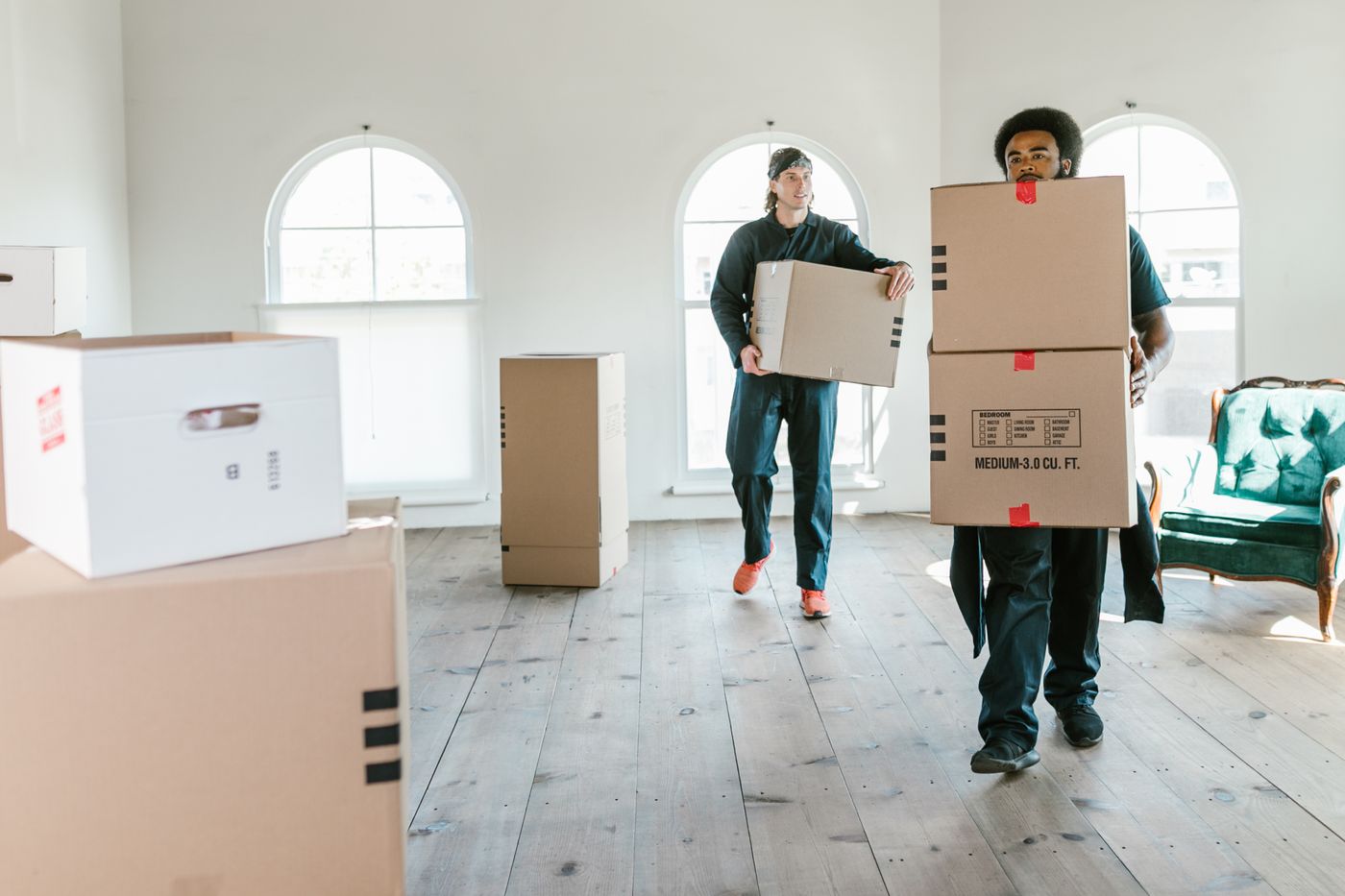 Movers clearing a house of boxes