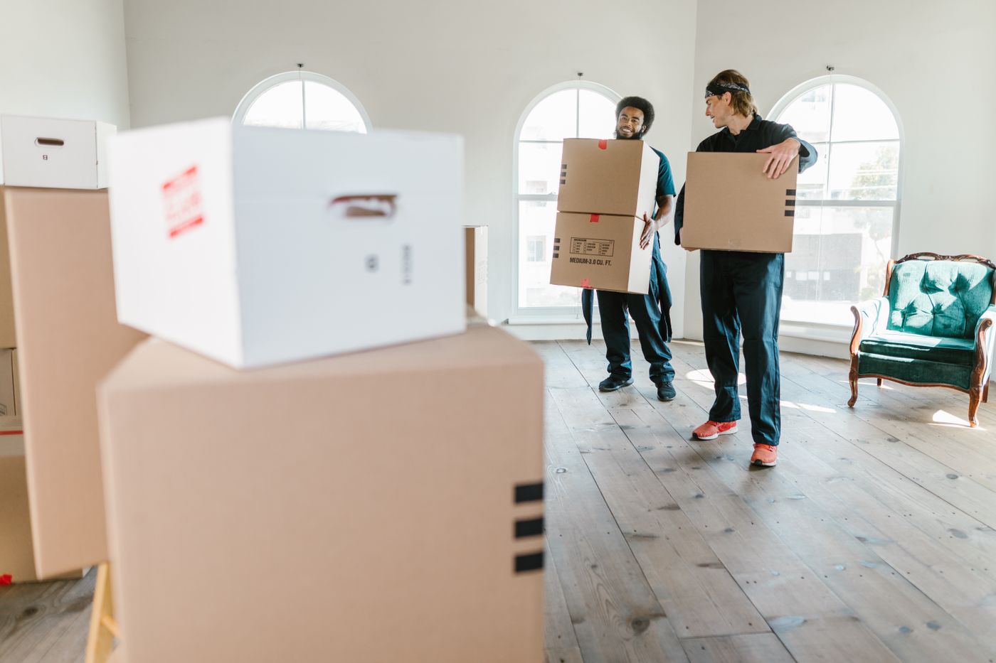 Movers carrying boxes indoors