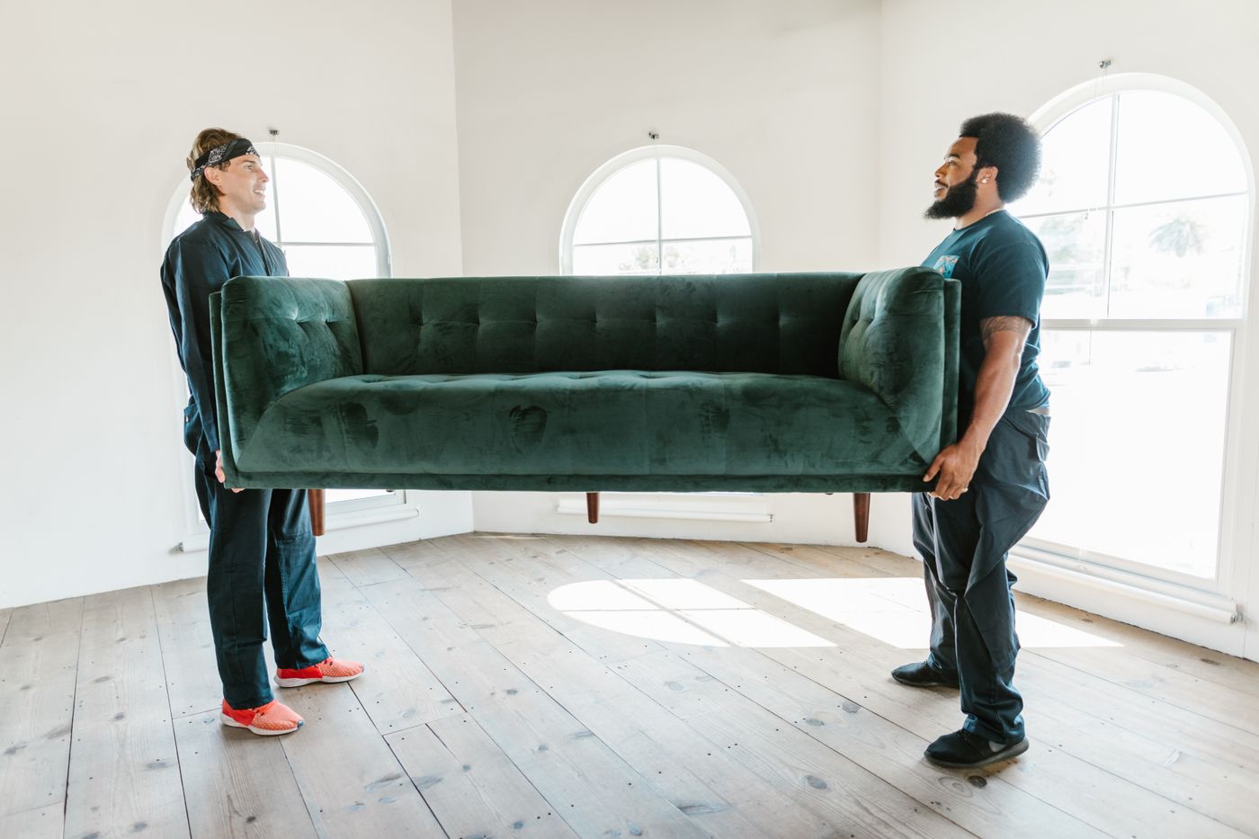 Two movers carrying a sofa