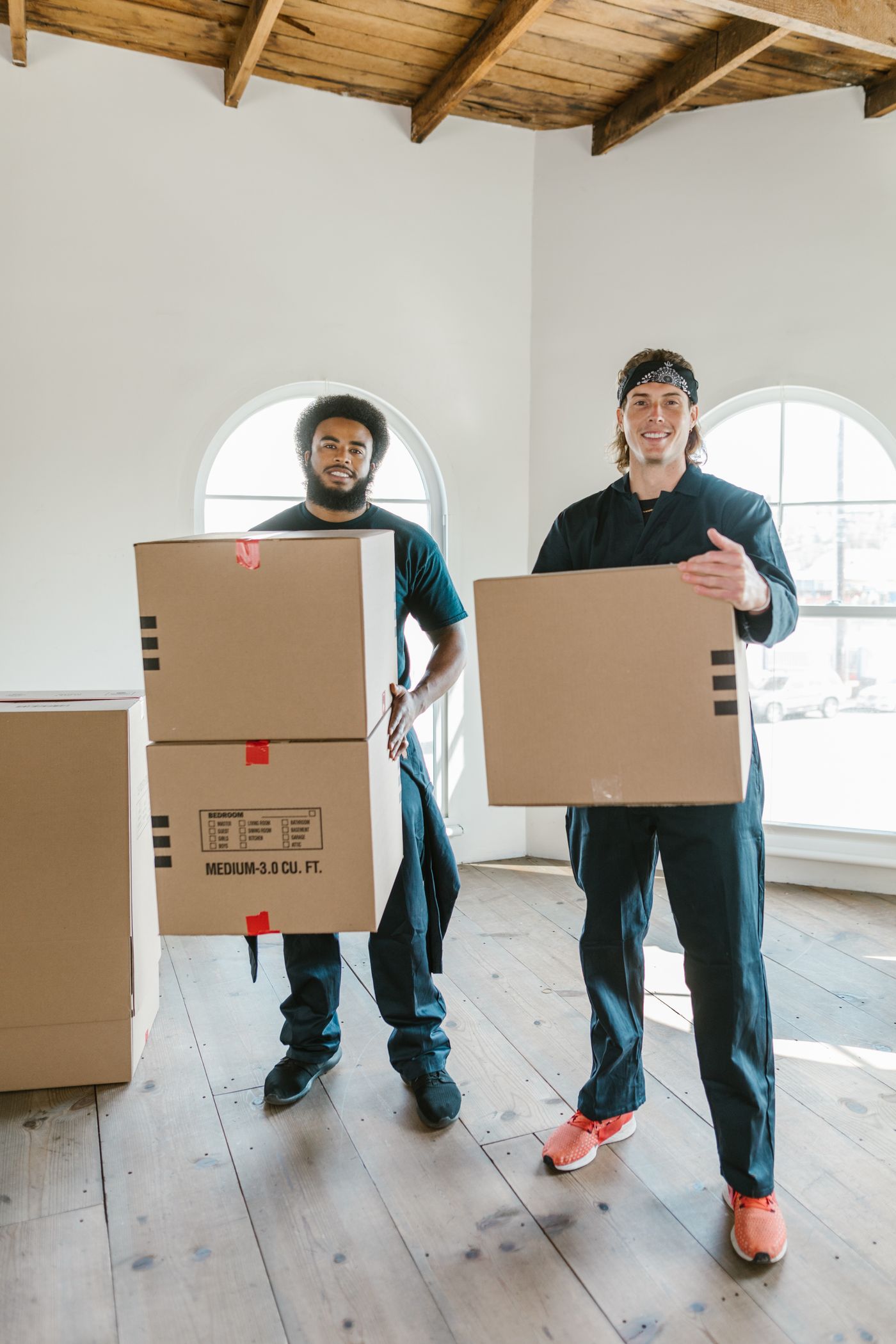 A friendly two-man removals team with moving boxes